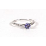 A 9ct white gold ring set with a solitaire tanzanite and diamond shoulders. Approx UK size N