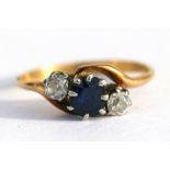 An 18ct gold diamond & sapphire crossover ring, approx UK size 'M'.