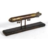 A superb brass and copper model of the Zeppelin R101 mounted on a wooden base. Overall length of