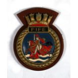 A hand painted aluminium ships crest or plaque mounted on a wooden shield to HMS Fife. Overall