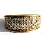 A 9ct gold ring set with fifty two diamonds in four rows, approx UK size 'M'.