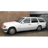 A white Mercedes 300TD diesel estate car, first registered 1992.