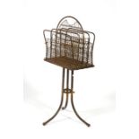 A Victorian oak and brass four-division magazine rack, 38cms (15ins) wide.