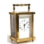 An Excalibur brass cased carriage time piece, the white face with Roman numerals, 11cms (4.25ins)