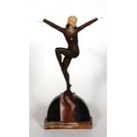 An Art Deco style bronzed figure depicting a dancing lady mounted on a marble plinth. 32cm (12.5
