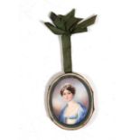 A 19th century portrait miniature depicting a young lady wearing a blue dress, 5 by 6cms (2 by 2.