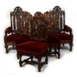 A set of twelve Victorian oak dining chairs with carved and pierced backs and upholstered seats,