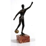 An Art Deco style patinated bronze figure of a footballer, mounted on a rouge marble plinth,