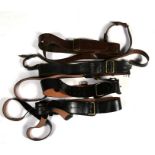 Four Sam Browne belts with their cross straps