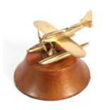 A polished bronze / brass Schneider Cup Spitfire model on a turned wooden plinth, wingspan 16cms (