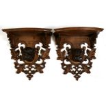 A pair of Black Forest wall brackets carved with central Bull Mastiff head, 41cms (18ins) wide.