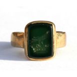 A 9ct gold signet ring with green stone intaglio crest of a bird on a crown, approx UK size 'O'.