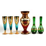 A group of Bohemian gilded vases and wine glasses.