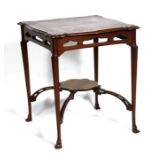 An Art Nouveau mahogany two-tier occasional table with pierced frieze, 60cms (23.5ins) wide.