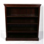 A late 19th century walnut open bookcase with three adjustable shelves, on a plinth base, 106cms (