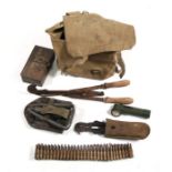An army issue canvas kit bag containing wire cutters, trench spade and other items.