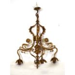 An Art Nouveau gilt brass three-arm ceiling light with Tudor rose decoration, 53cms (20.75ins)