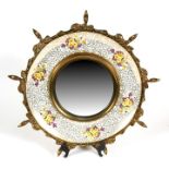 An Art Master chintz porcelain brass mounted wall mirror, 44cms (17.25ins) diameter.