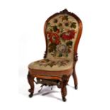 A Victorian walnut chair with needlepoint upholstered seat and back, on carved cabriole front