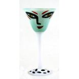 A Kosta Boda Art Glass goblet designed by Ulrica Hydman-Vallien, decorated with a stylised face on a