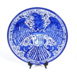 A large German blue & white charger with eagle motif, 39cms (15.25ins) diameter.