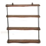 A set of 19th century walnut open wall shelves with brass supports, 64cms (25ins) wide.