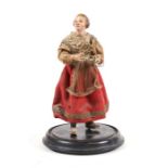 A 19th century Italian carved wood & composition creche figure of a lady wearing a red dress,