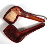 A 19th century continental Meerschaum pipe carved in the form of a Snipe, with amber mouth piece,