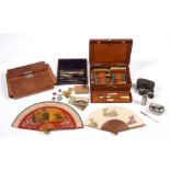 An early 20th century leather cased gentleman's vanity case; together with another similar; a WWII