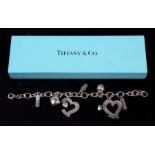 A silver charm bracelet, marked Tiffany & Co, boxed.