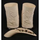 A pair of early 20th century carved African ivory table lamps, 19cms (7.5ins) high; together with