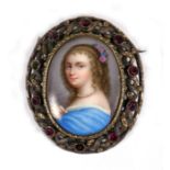 An enamel portrait miniature of a young lady in a white metal gem set brooch mount, 5cms (2ins)