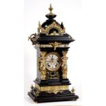 A 19th century German mantle clock, the silvered dial with Roman numerals, the ebonised case