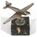 A chrome plated model of a twin engined fighter mounted on a marble base, possibly the Westland