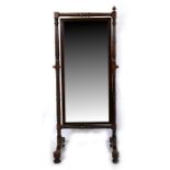 A 19th century mahogany cheval mirror on turned supports, 74cms (29ins) wide.