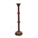 A Gothic style turned oak candle stand, 105cms (41.25ins) high.