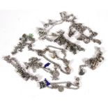 Ten silver charm bracelets and charms, 270g.