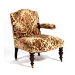 A Victorian open armed armchair with upholstered seat and back, on turned front supports.