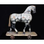 A Victorian painted wooden pull-along toy horse, 23cms (9ins) high.