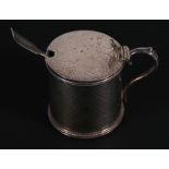 A large Victorian silver mustard pot with engraved decoration, London 1868, with associated silver