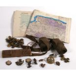 A quantity of military cap badges; military brass buttons, military maps; and other items.