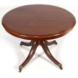 A 19th century mahogany breakfast table on turned column and quatrefoil base, 102cms (40ins) wide.