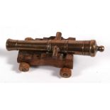 A good quality bronze barrelled signal cannon mounted on a wooden carriage. Barrel length 12.5cms (