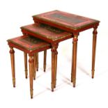A nest of three Italian painted and giltwood tables, the largest 58cms (22.75ins) wide.