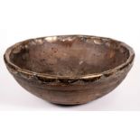 An early fruitwood and white metal mounted bowl or quaiche, 37cms (14.5ins) diameter.