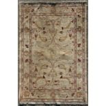 A Caucasian rug decorated with flowers and foliate scrolls on a cream ground, 121 by 170cms (47.5 by