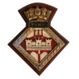 A hand painted aluminium ships crest or plaque mounted on a wooden shield to HMS Tyne. Overall