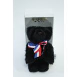 A boxed Merrythought black teddy bear