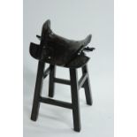 A stained elm horse saddle, on later mounted stand, possibly Chinese