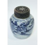 A Chinese blue and white vase ginger jar decorated with landscape scenes, with a wooden pierced lid